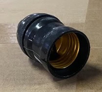 Close-up of black and gold plumbing fitting for water systems.