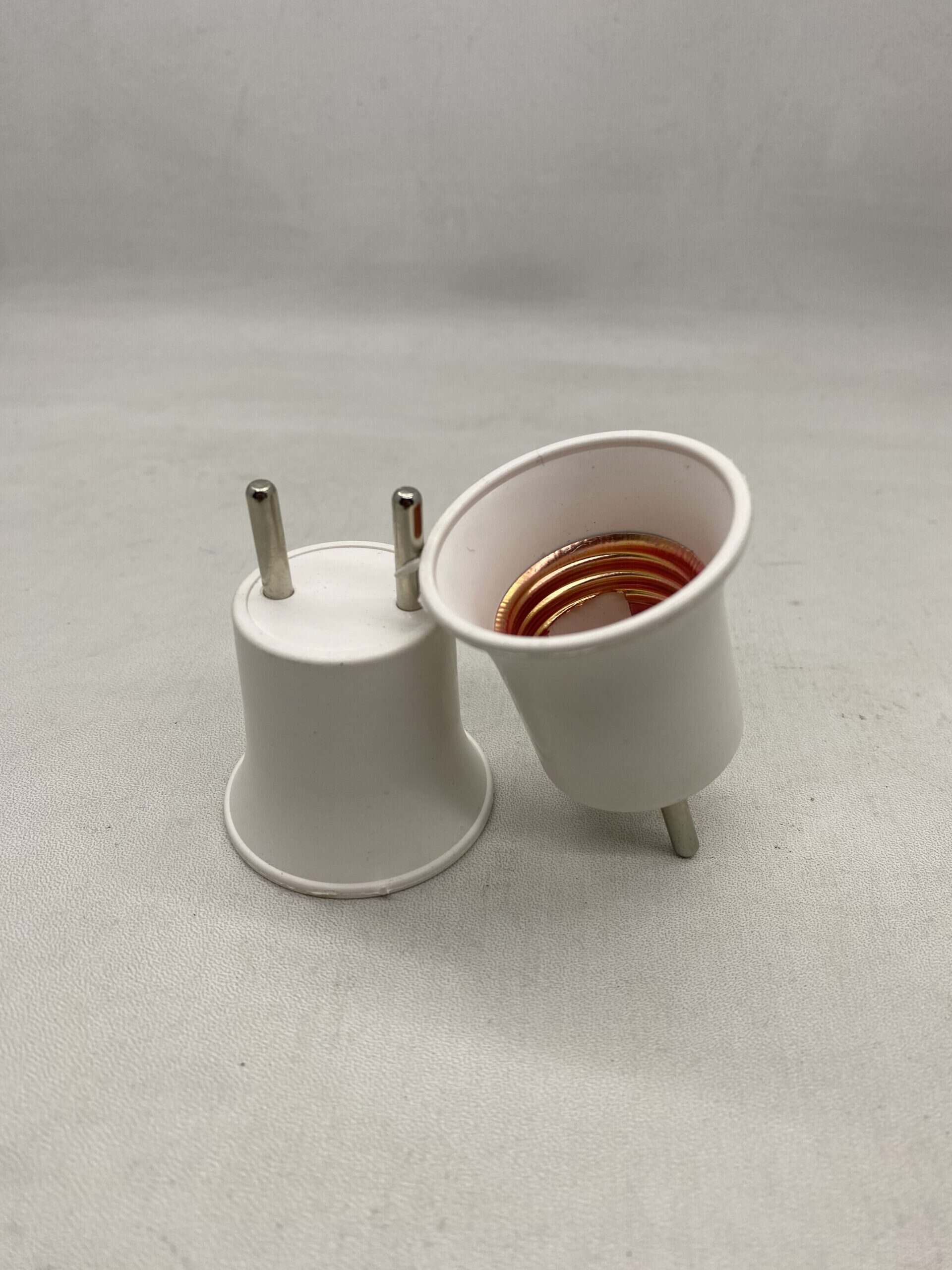 Electrical plug adapters for power outlets with copper contacts.