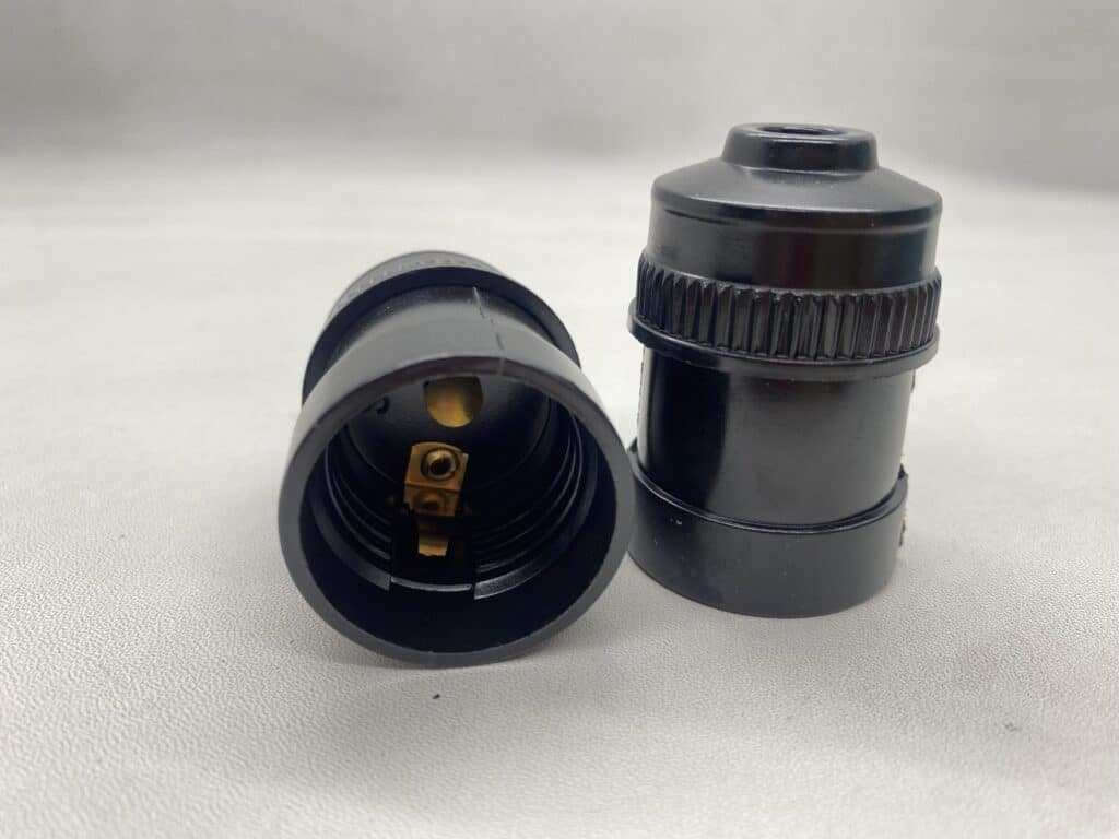 Close-up of black electrical fitting for versatile wiring connections.