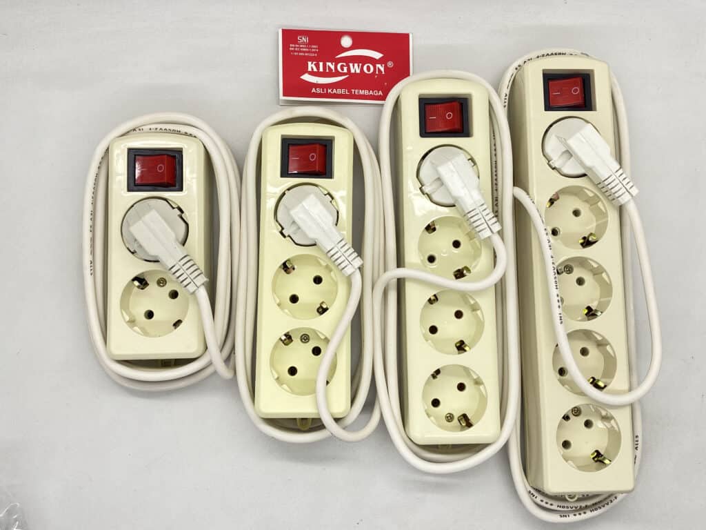 Power strip with multiple sockets and connected cables for electrical devices.