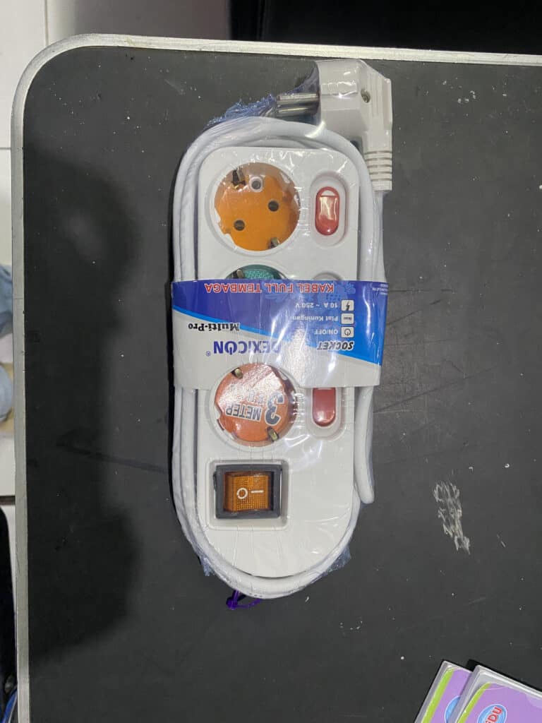 Power strip with multiple electrical outlets and connected cables for versatile power supply.