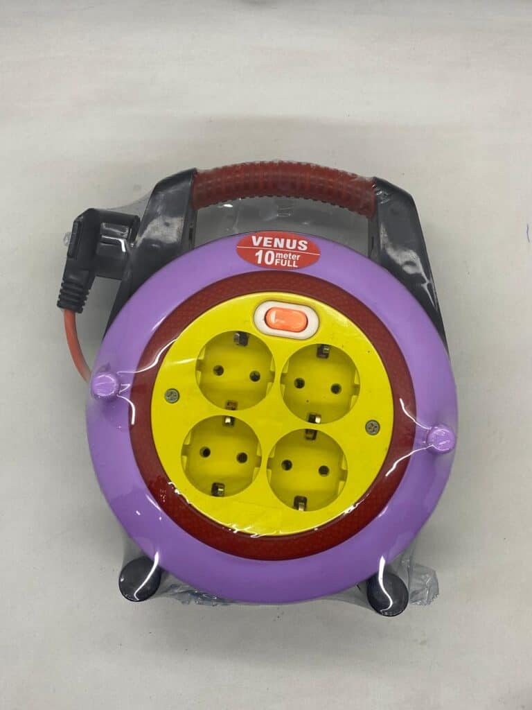 Compact electrical extension cord with four sockets and safety cover.
