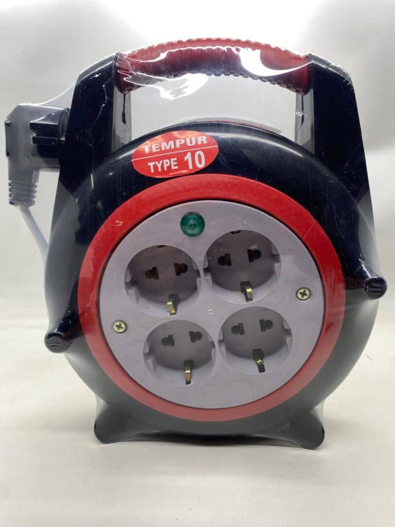 Extension cord with multiple outlets and safety cover for electrical devices.
