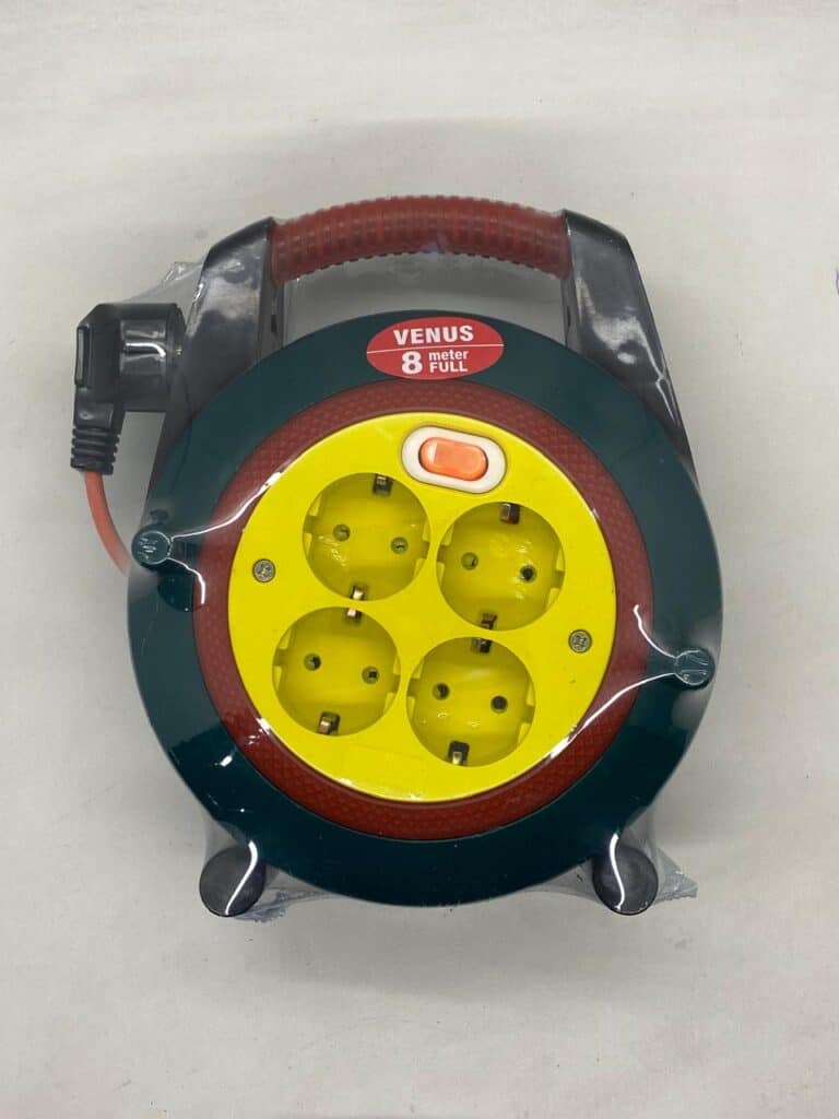 Extension cord reel with four power outlets and safety cover, suitable for electrical appliances.