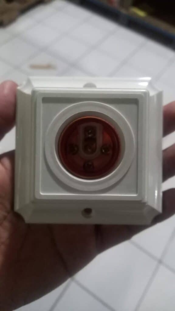 Electrical socket with safety cover for secure fitting.