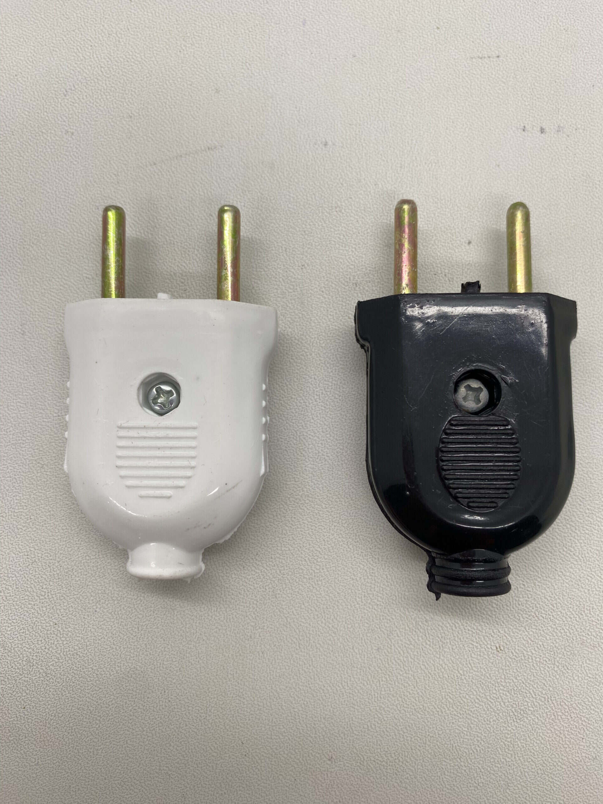 Power plug adapters for electrical appliances, white and black, used for connecting devices to diffe.